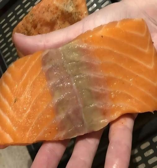 I bought salmon a week ago and wanted to make it for dinner today. When I took it out of the refrigerator, it had a yellow stain on it. What is it?
